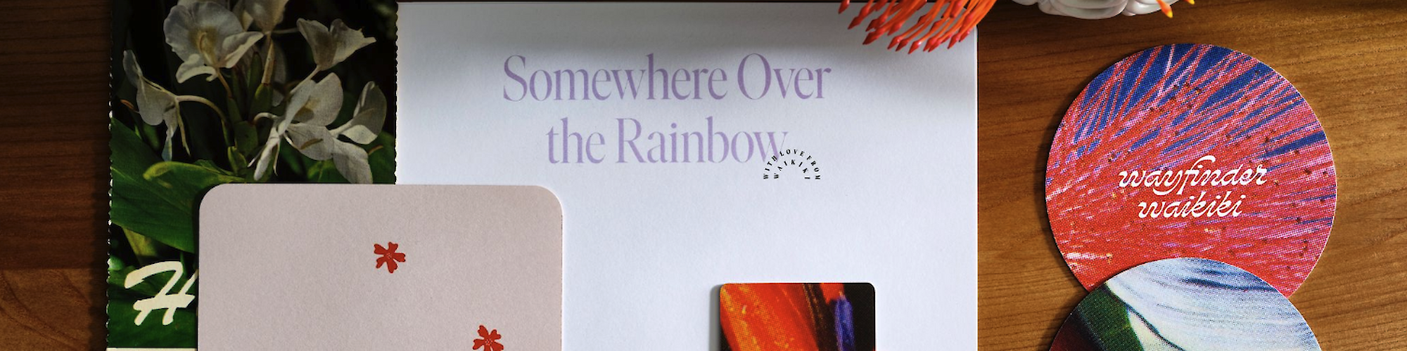 This image shows a floral card, coaster cards with designs and text, and a paper reading "Somewhere Over the Rainbow" with a slot saying "Stop and Smell the Flowers."